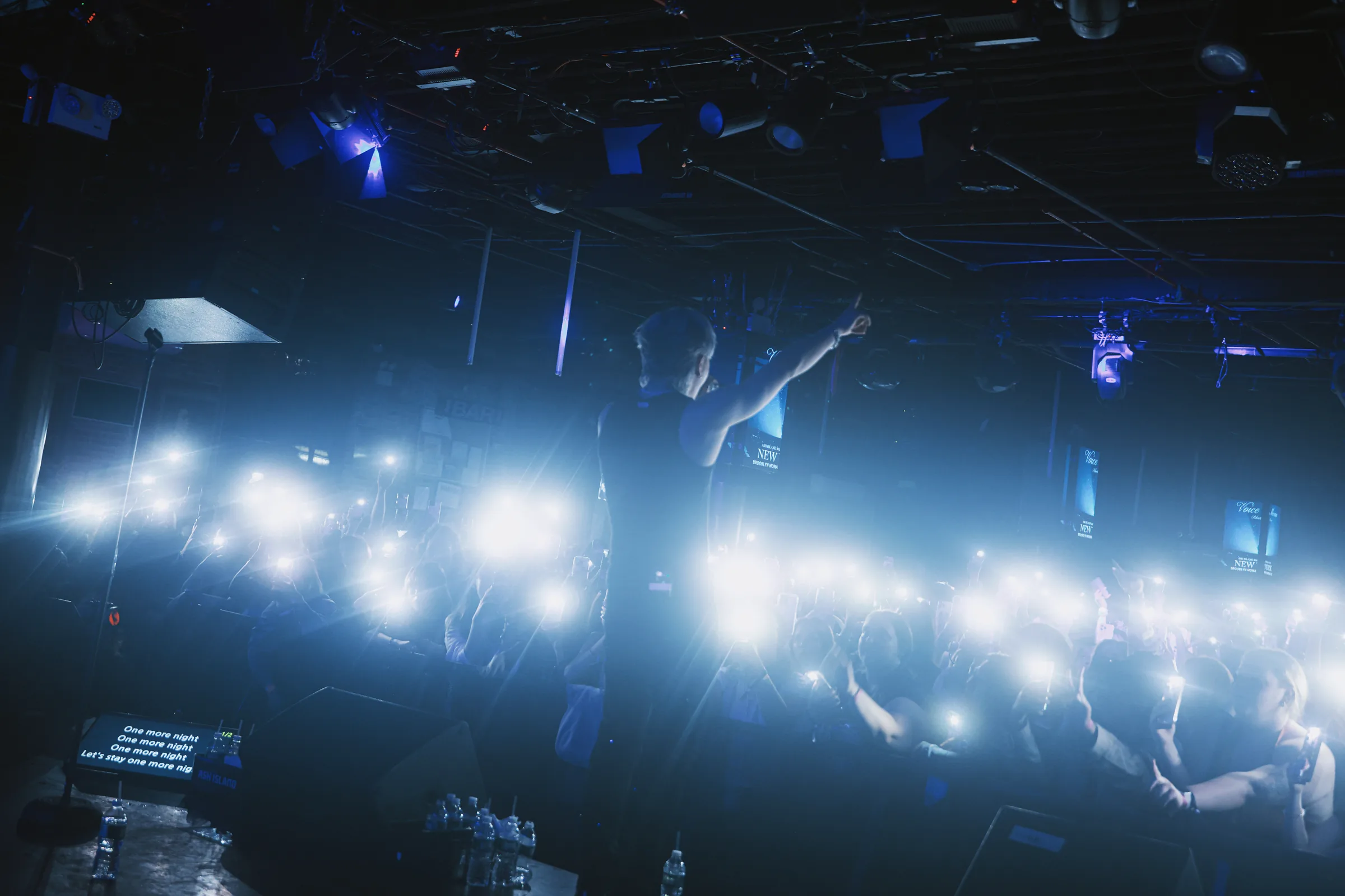 ASH ISLAND's stage and audience under a blue-white lighting array