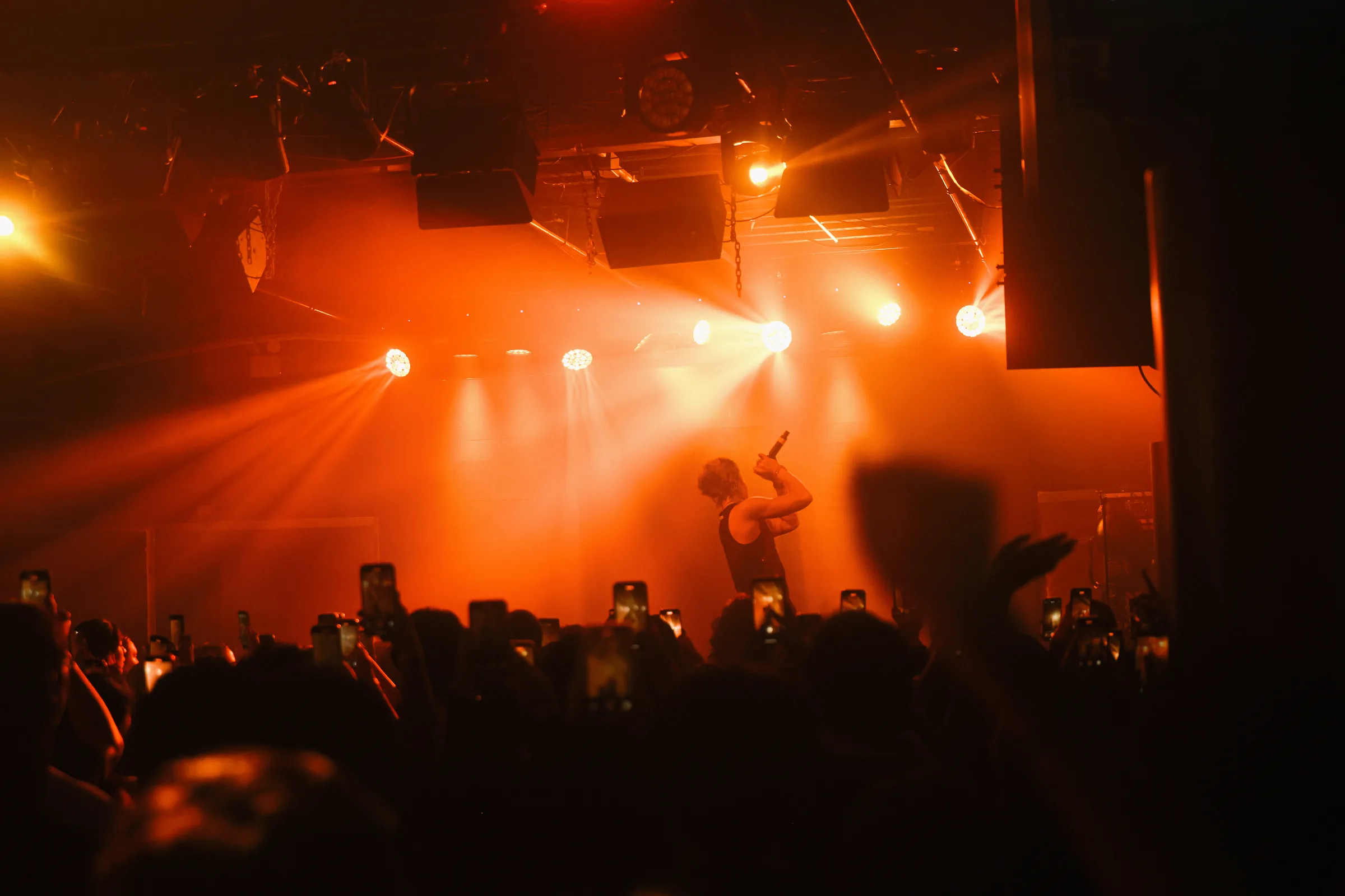 ASH ISLAND and the audience under orange concert lighting