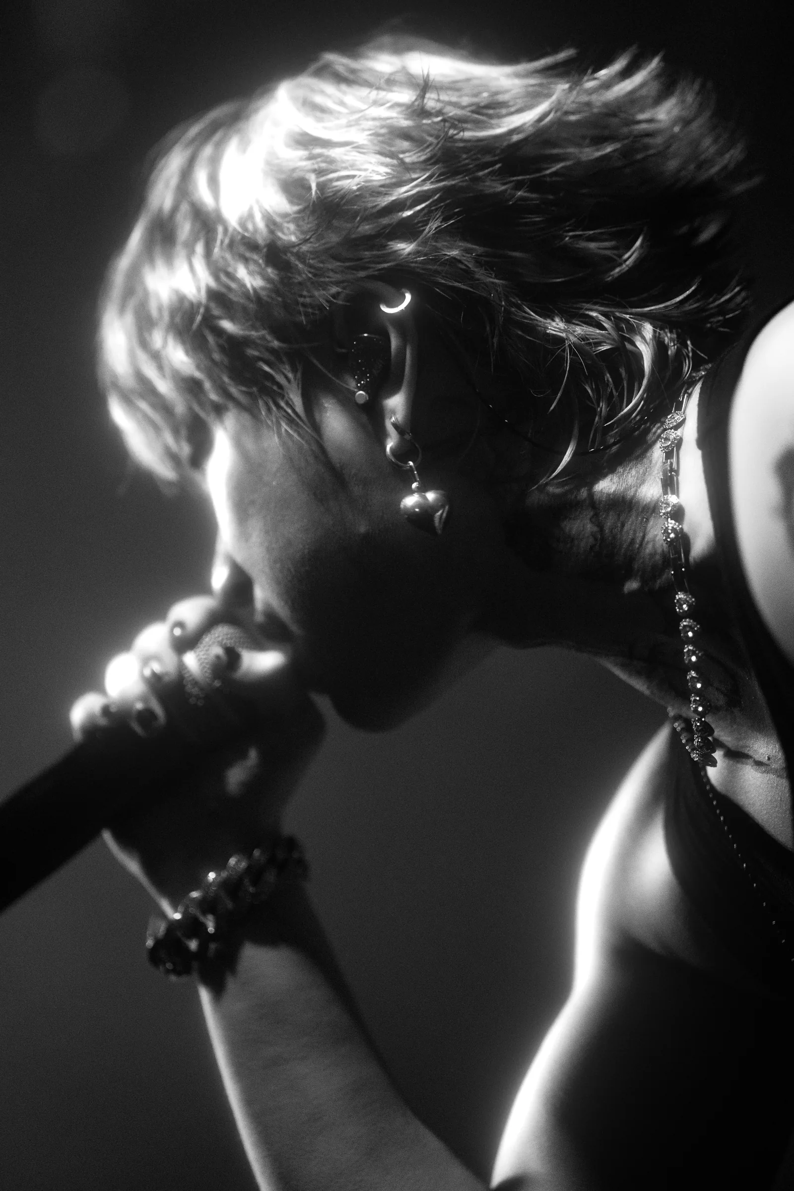 ASH ISLAND singing in profile in a black-and-white live portrait