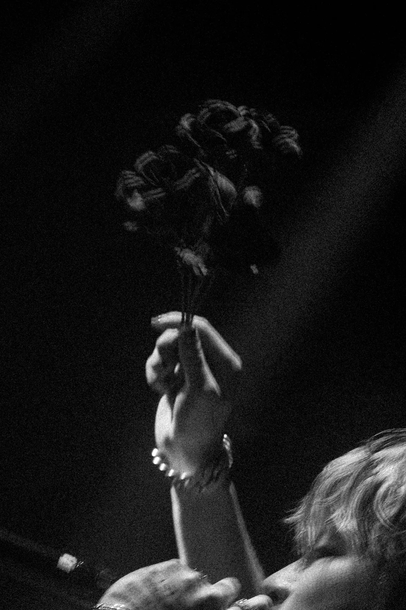 A fan holding a black rose during ASH ISLAND's Vancouver show